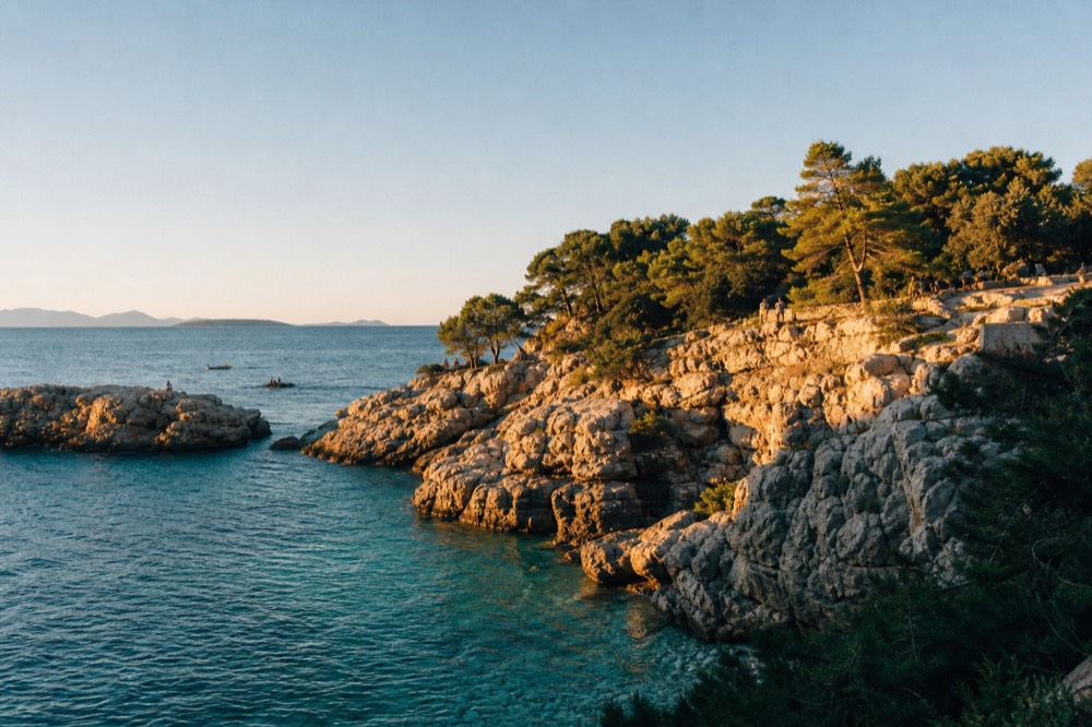 Clear turquoise water against pale limestone rocks on a small island cove