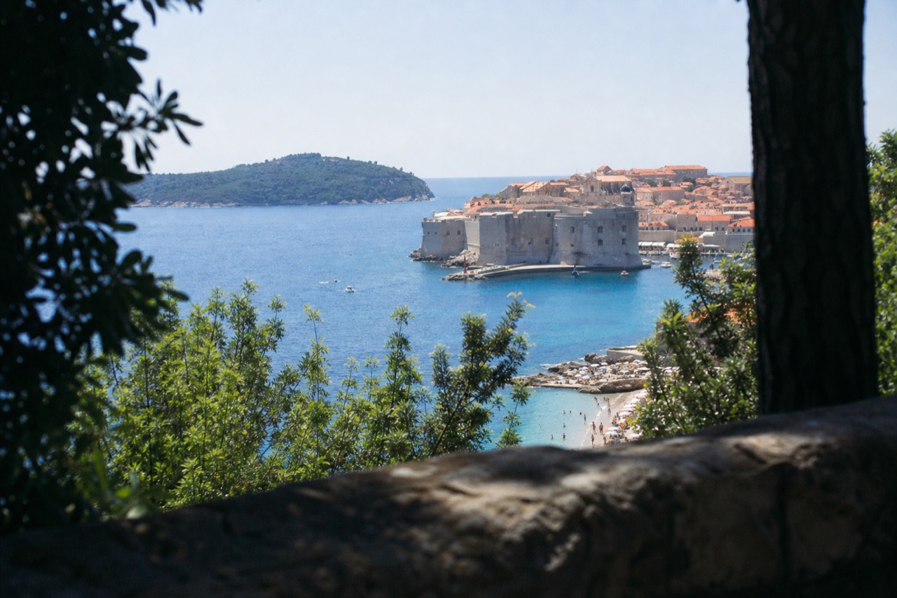 View of Banje Beach with Dubrovnik Old Town walls and Lokrum Island in the distance