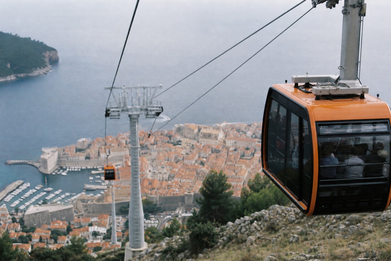 Cable car cabins on the line between Dubrovnik Old Town and the hilltop station above the red roofs