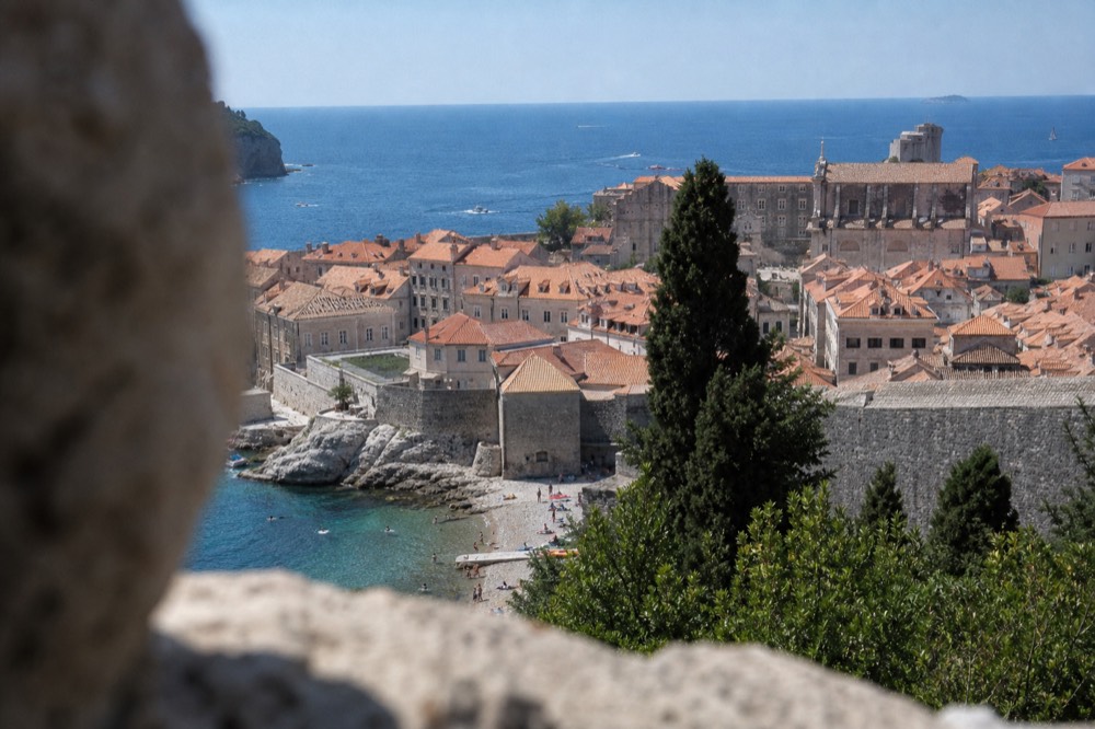 Wide view over Dubrovnik Old Town rooftops toward the Adriatic Sea