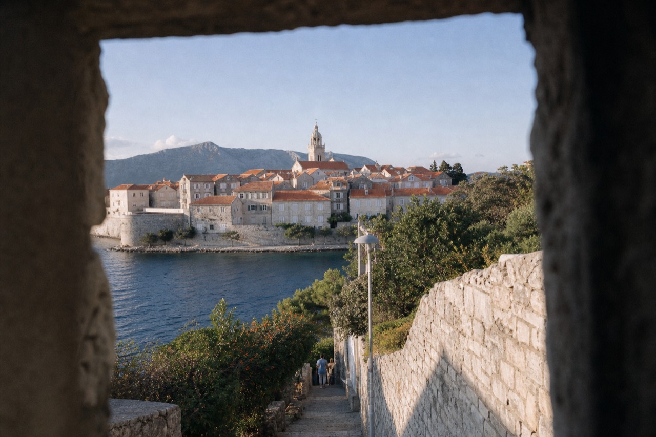 Walled town of Korcula seen from the water with terracotta roofs and a church tower