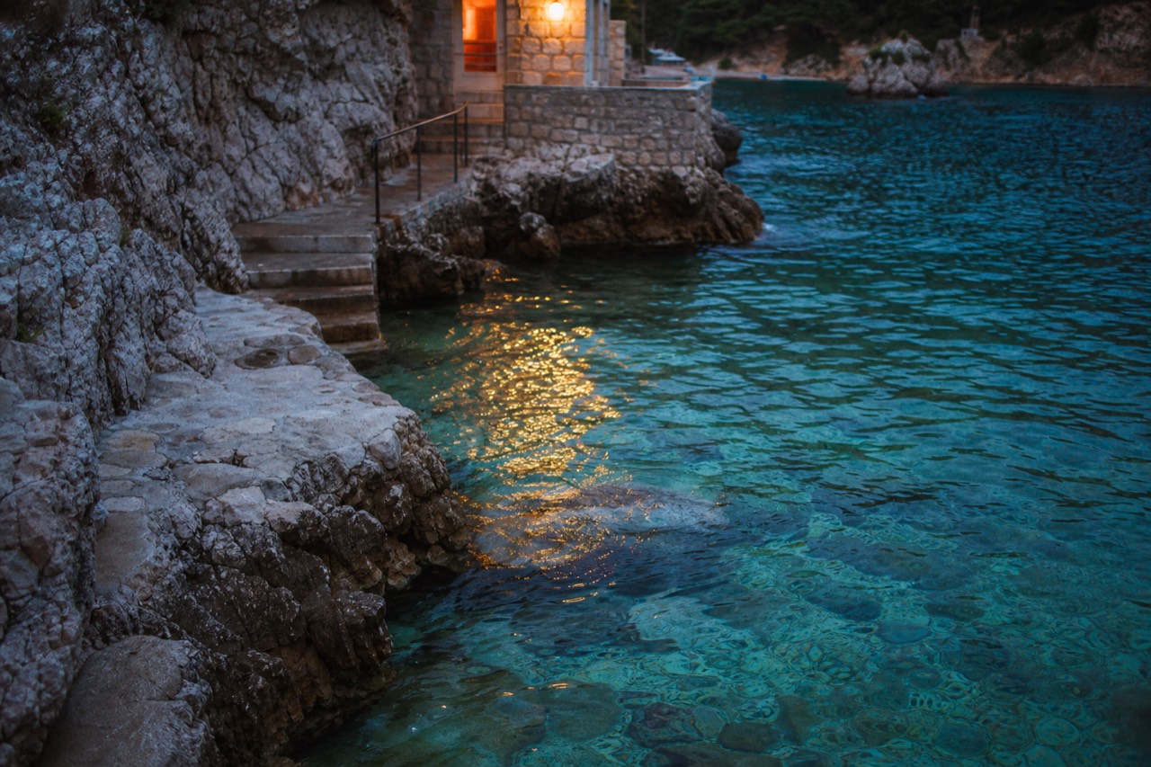Clear turquoise water against pale limestone rocks on a quiet Adriatic cove