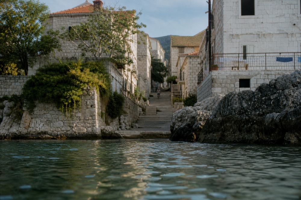 Narrow stone staircase street climbing between old town buildings