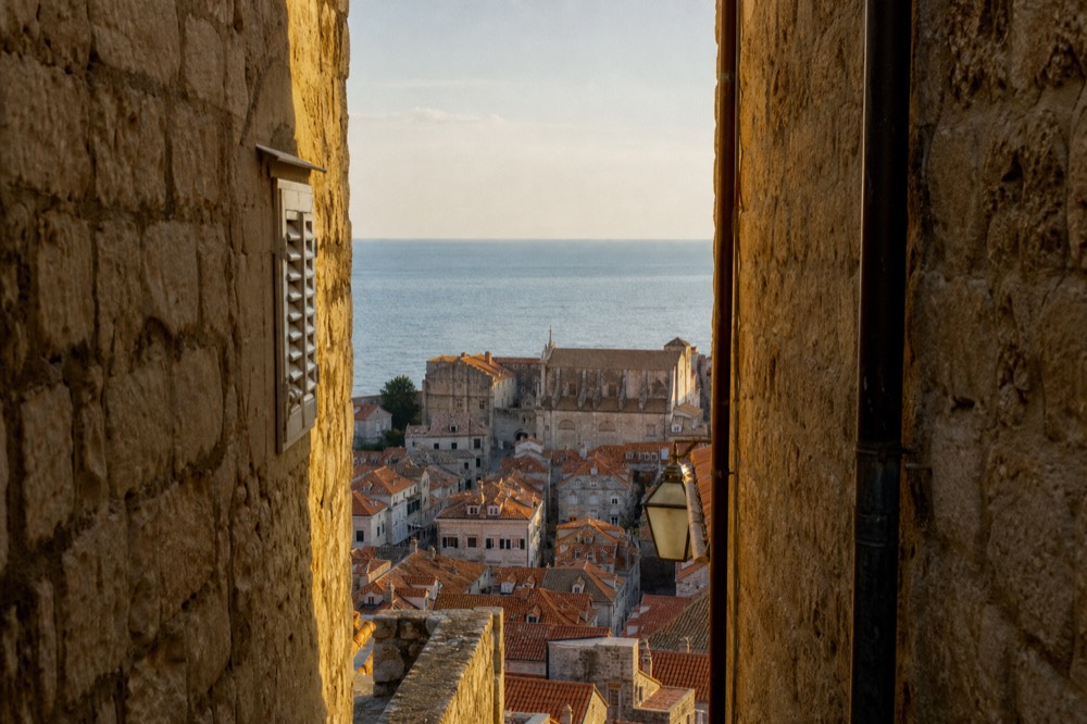 Red rooftops of Dubrovnik Old Town seen from above with the Adriatic sea beyond