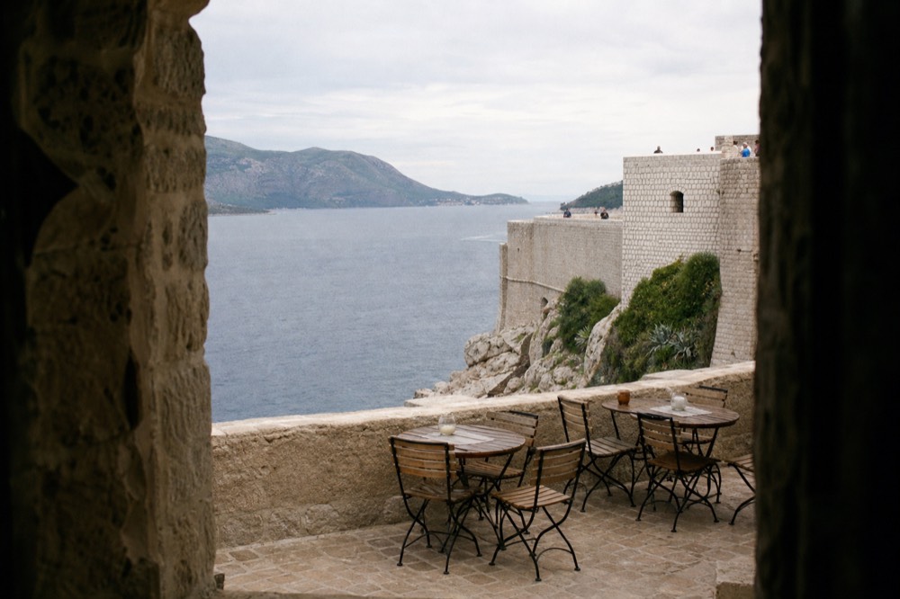 Cliffside bar terrace on the outer face of Dubrovnik city walls above the sea