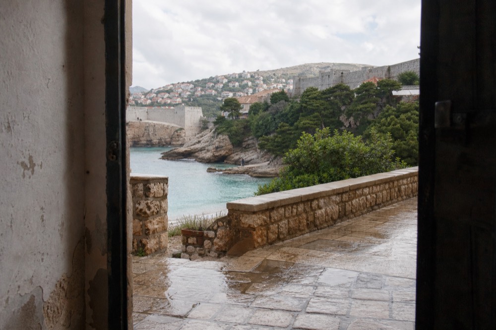 Clear turquoise water at a stone beach below Dubrovnik with rocky shoreline