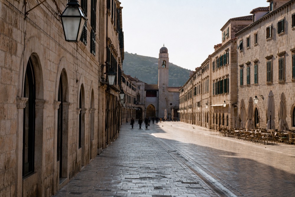 The limestone Stradun street in Dubrovnik Old Town on a bright morning with long shadows