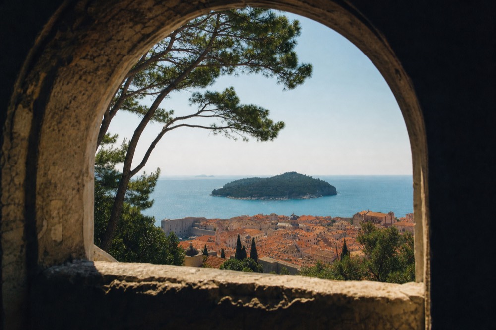 Spring sunshine on the red rooftops of Dubrovnik Old Town with the island of Lokrum in the distance