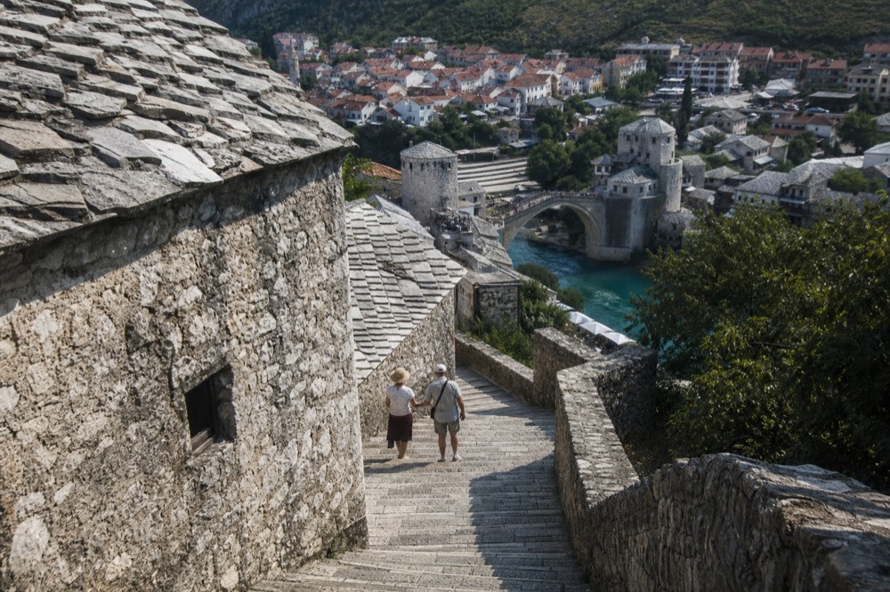Mostar old town rooftops with the stone bridge and turquoise river below