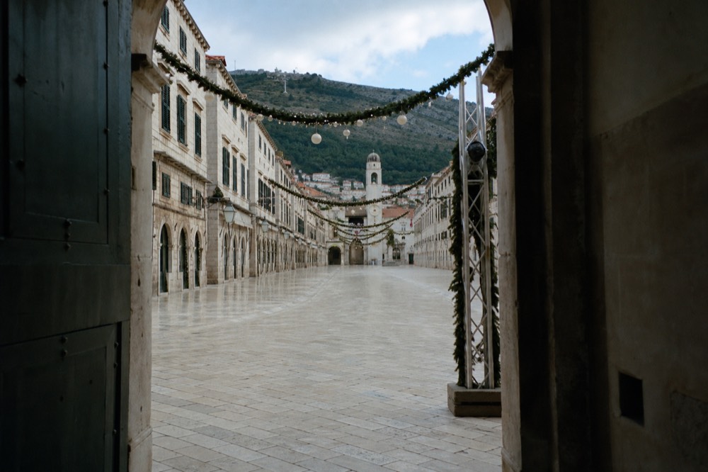 Stradun street decorated with festive lights and empty of crowds in winter