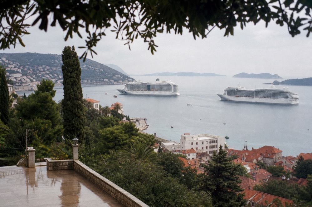 Two cruise ships anchored in the bay outside Dubrovnik's harbour at midday