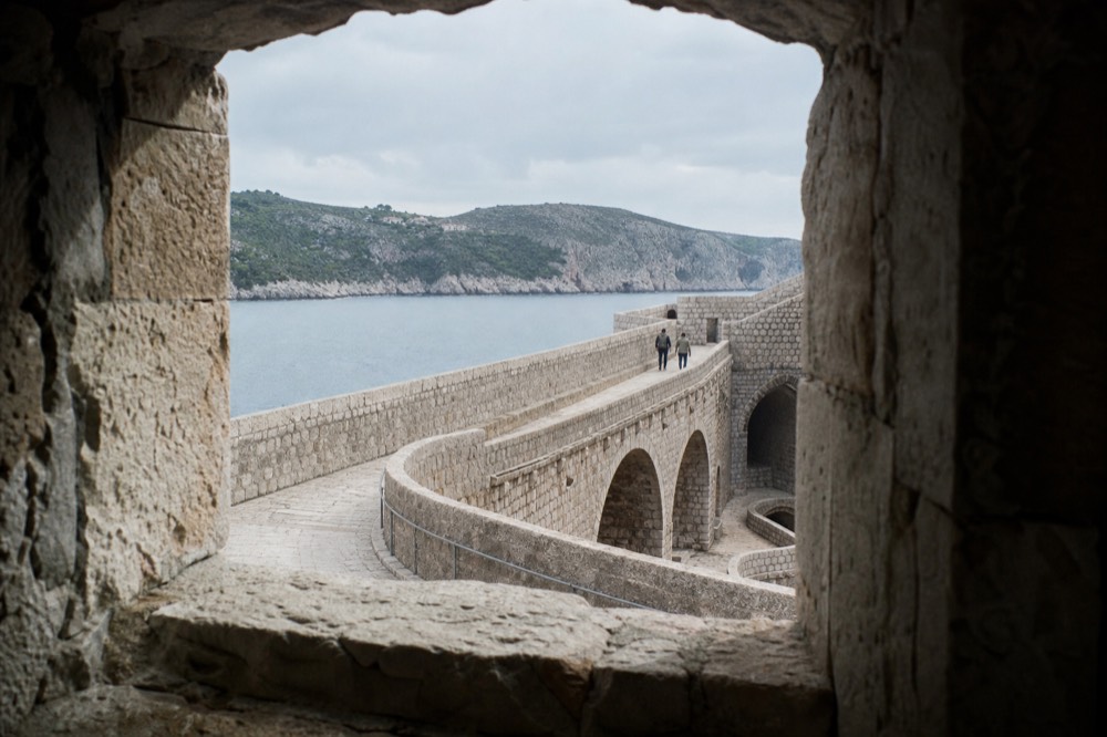 Thick stone walls and arched passages of an old Dubrovnik fortress interior