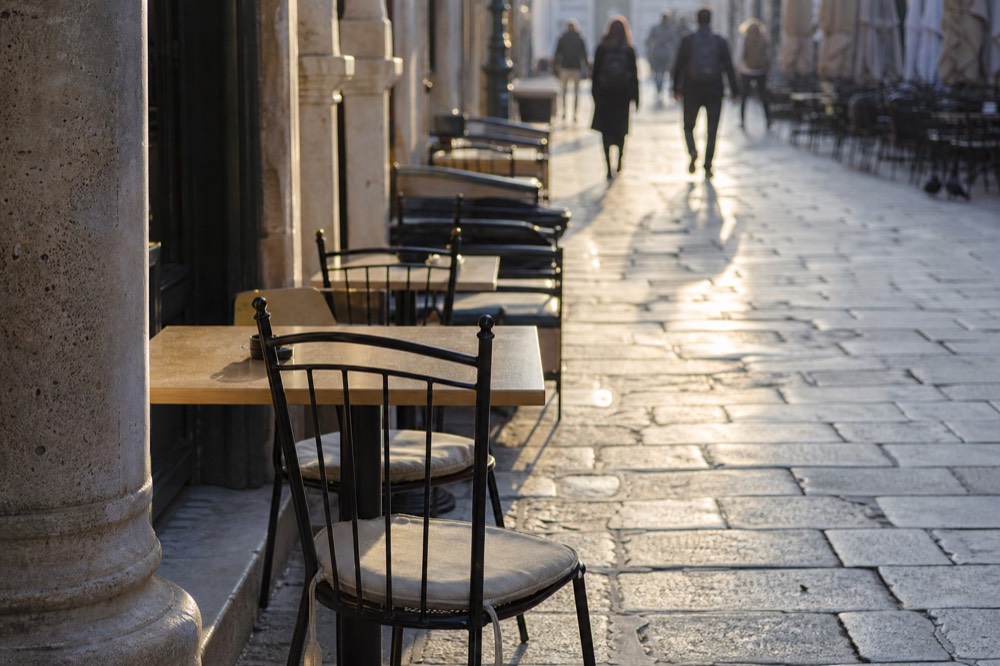 The Stradun in Dubrovnik with limestone paving and cafe tables along the sides