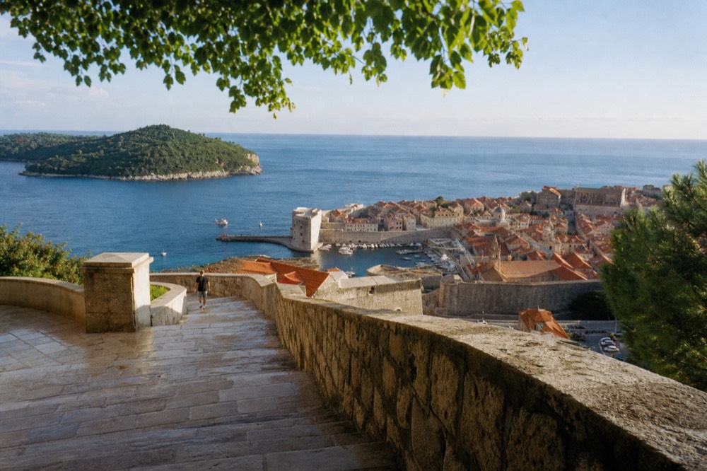 Old Town rooftops and the Adriatic sea seen from the city walls in bright morning light