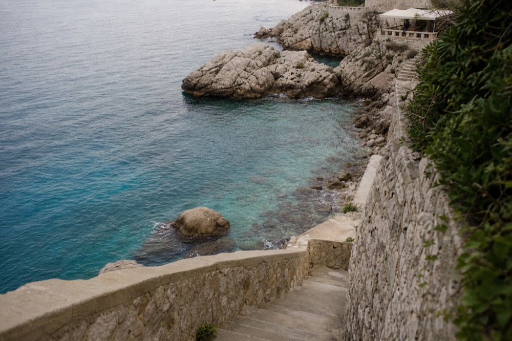 Clear turquoise water against rocks near Dubrovnik in autumn
