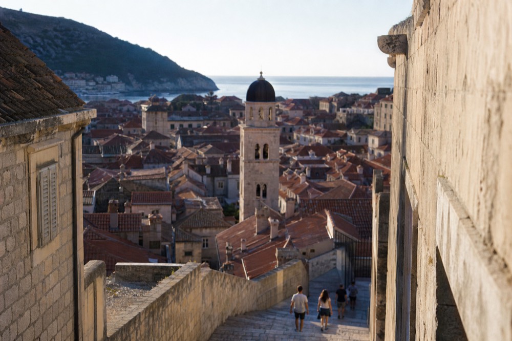 Sunset light on Dubrovnik Old Town rooftops and the bell tower seen from the city walls
