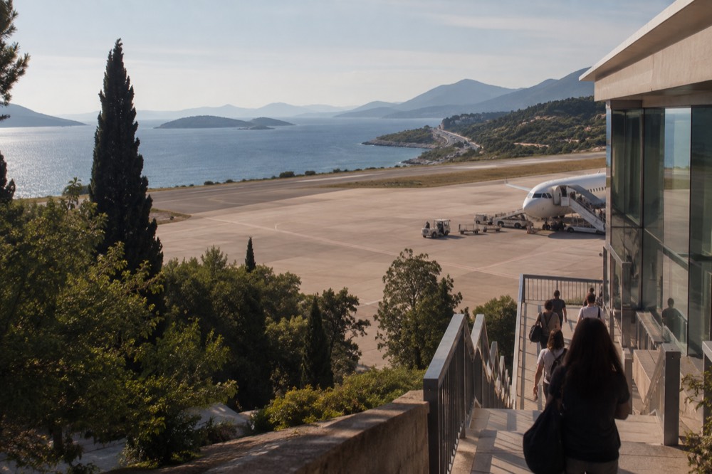 A long coastal road curving along the Adriatic with islands offshore