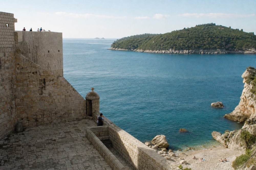 Fortress terrace with thick stone walls overlooking the Adriatic sea and a wooded island
