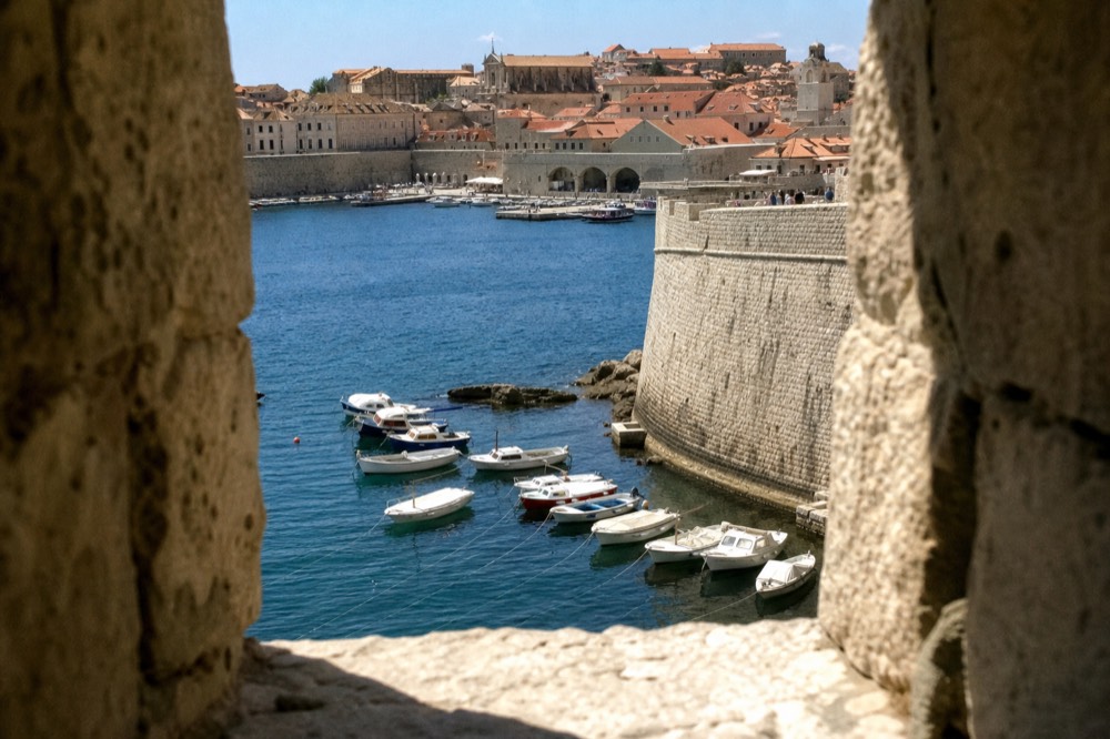 The Old City Harbour, small wooden boats moored below the harbour wall