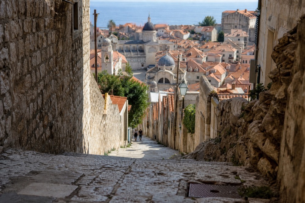 Panorama of terracotta rooftops and church towers seen from above