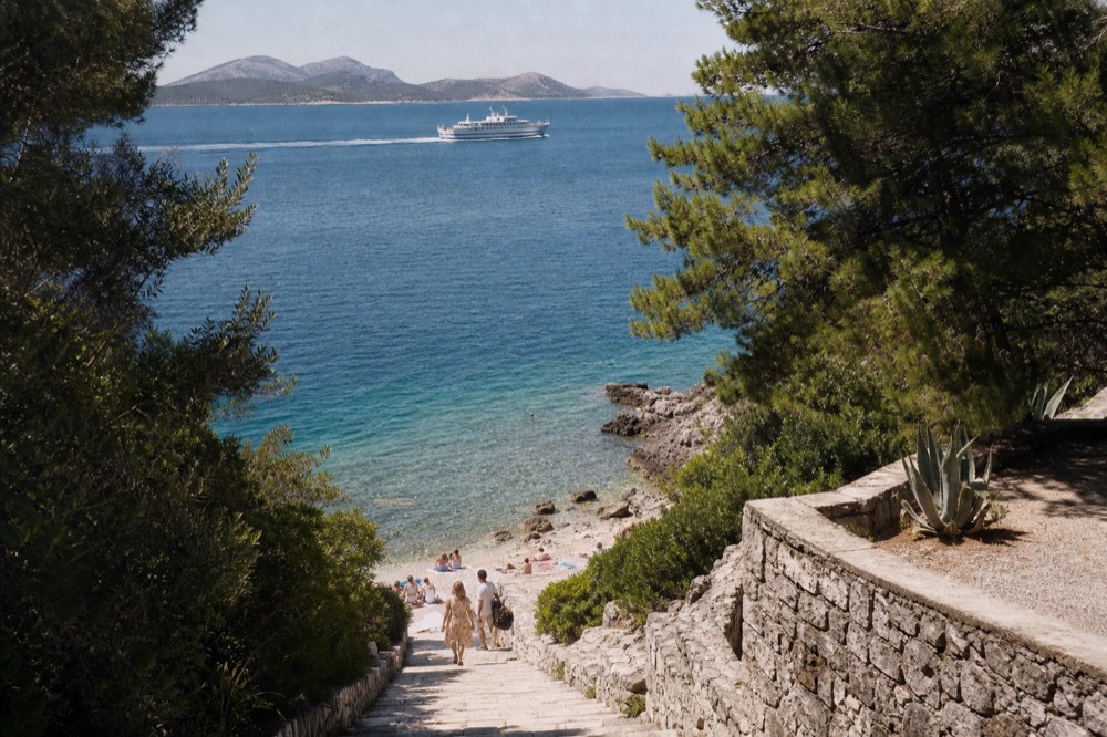 A ferry boat crossing open blue Adriatic water toward a distant island coastline