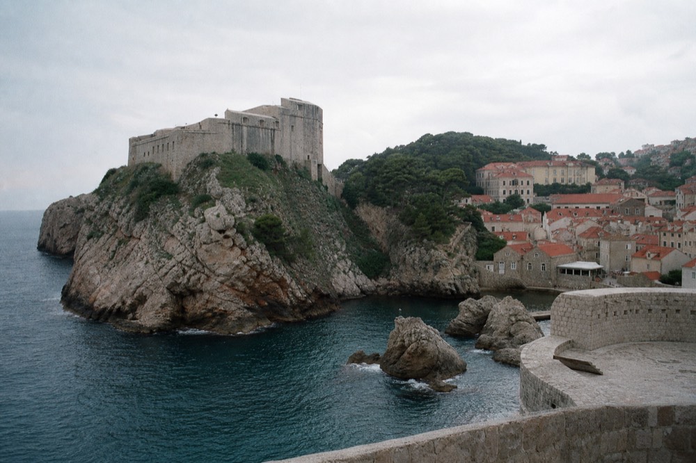 Fort Lovrijenac towering over the sea, with the Old Town walls in the background