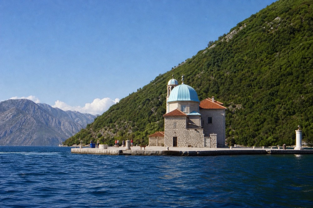 Small stone church on a tiny island in the Bay of Kotor near Perast