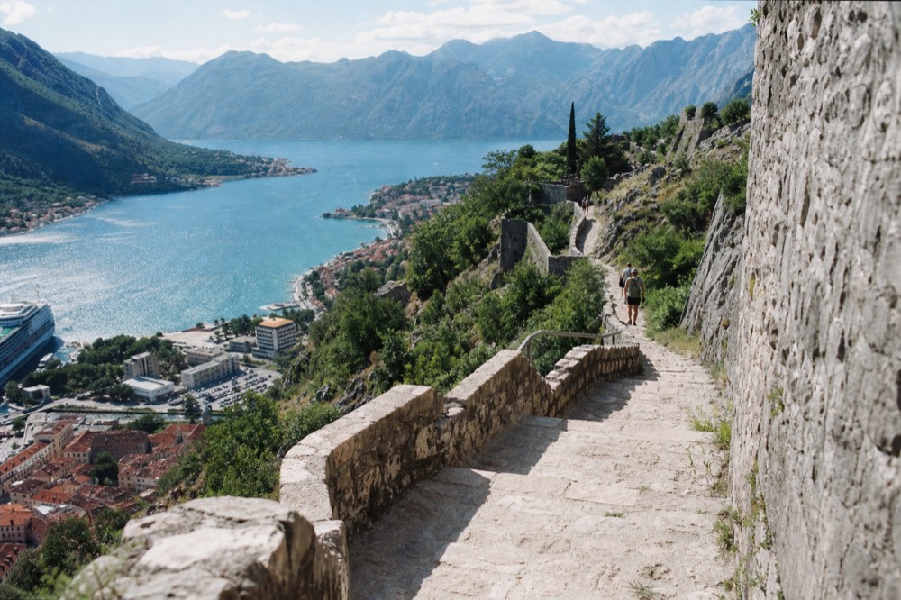 Zigzag stone wall path climbing the hillside above Kotor toward the hilltop fortress
