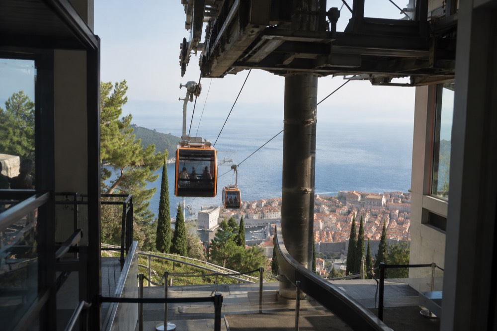 The lower cable car station building near the Old Town with cabins arriving on the cableway