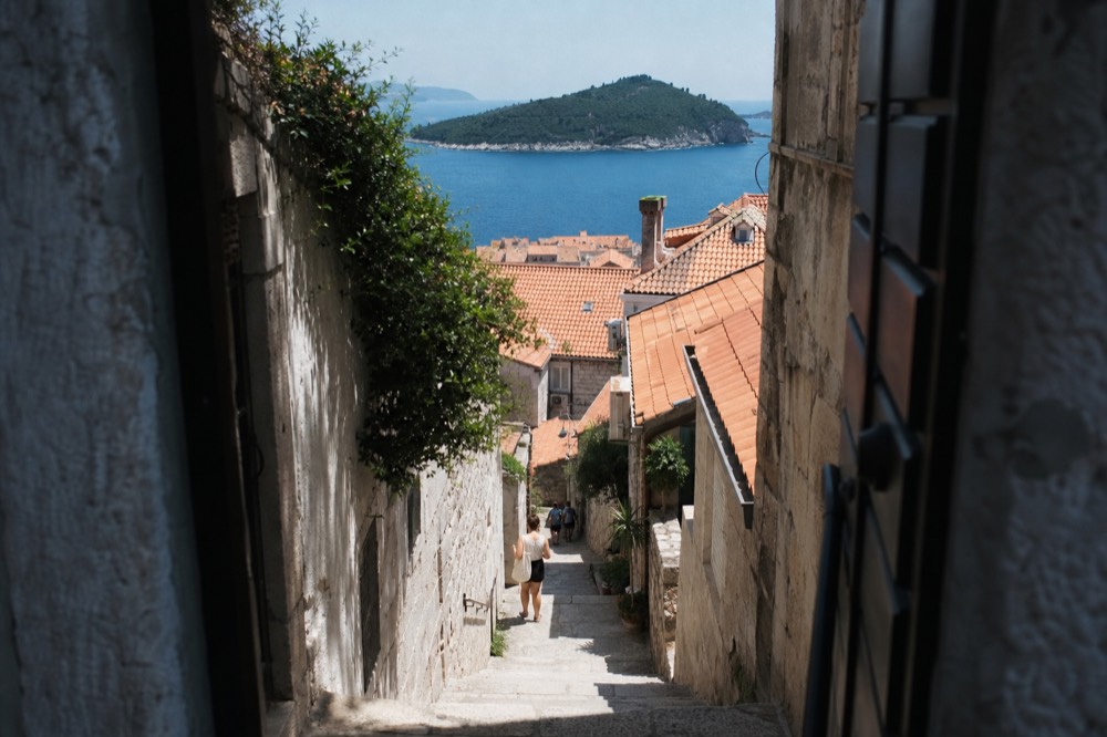 A narrow limestone alley in Dubrovnik with stone steps and no vehicles