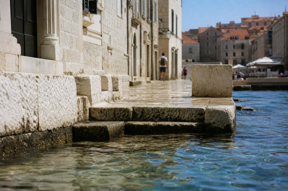 Close view of a polished limestone street in Dubrovnik Old Town with worn stone steps