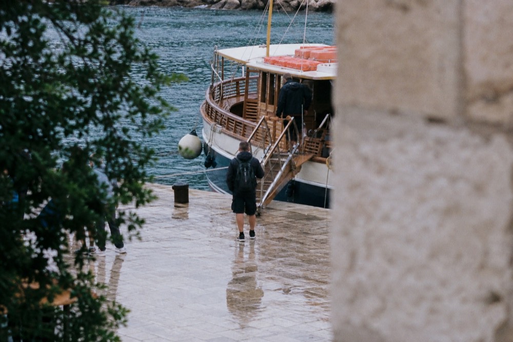 Wooden sightseeing boat moored at a quay with gangplank boarding