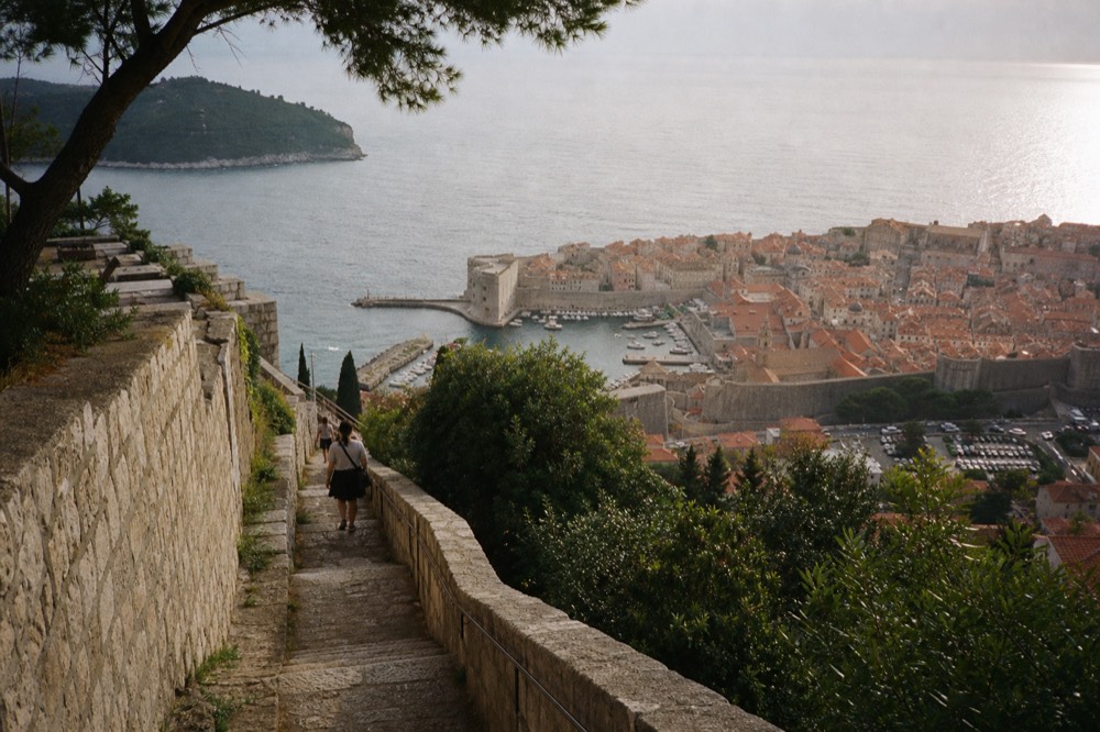 Golden evening light on the terracotta rooftops of Dubrovnik Old Town seen from above