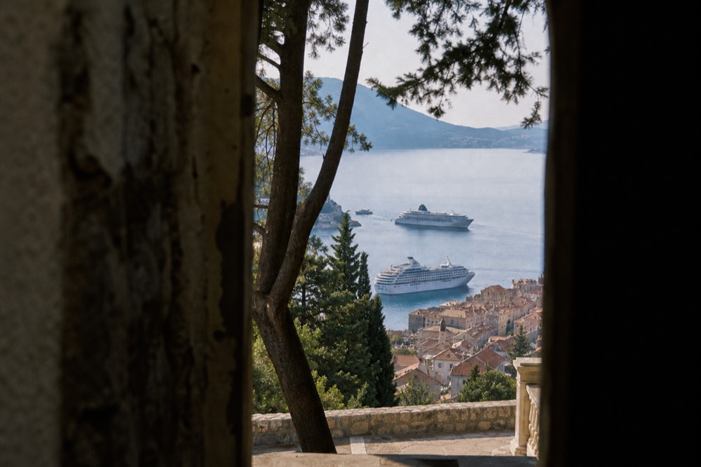 Two cruise ships anchored in the bay below Dubrovnik Old Town