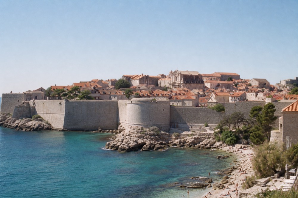 Clear turquoise water at a rocky beach below Dubrovnik's walls on a calm summer morning