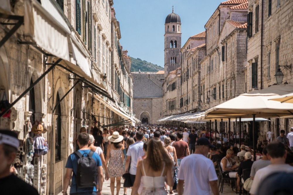 Crowded stone street in Dubrovnik Old Town with shops and cafes