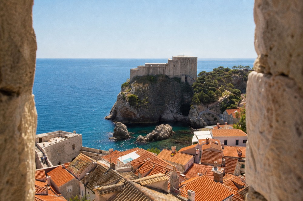 Fort Lovrijenac on its sea rock with the Adriatic stretching behind it and a clear blue sky