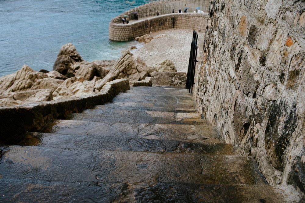 Wet stone staircase in Dubrovnik with rain droplets on the steps