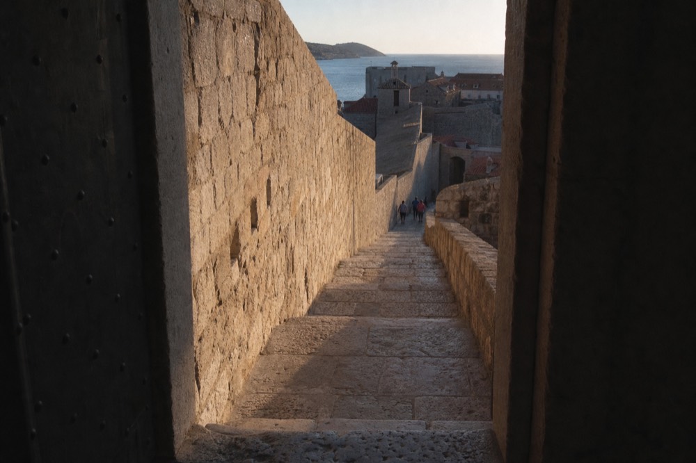 Empty stone stairway on the city walls shortly after sunrise with long shadows